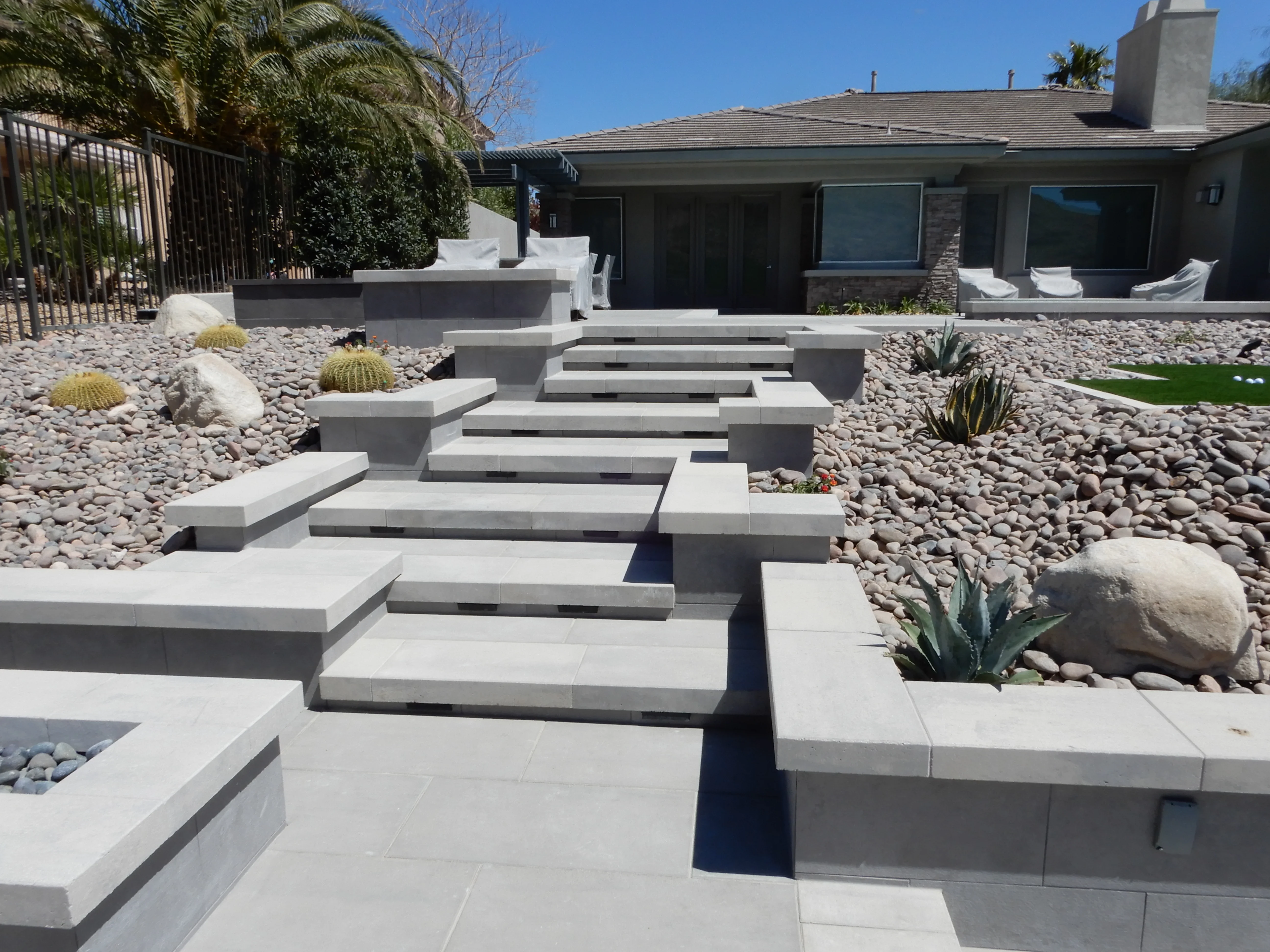 Modern concrete patio with geometric stepping stones and desert landscaping in Las Vegas