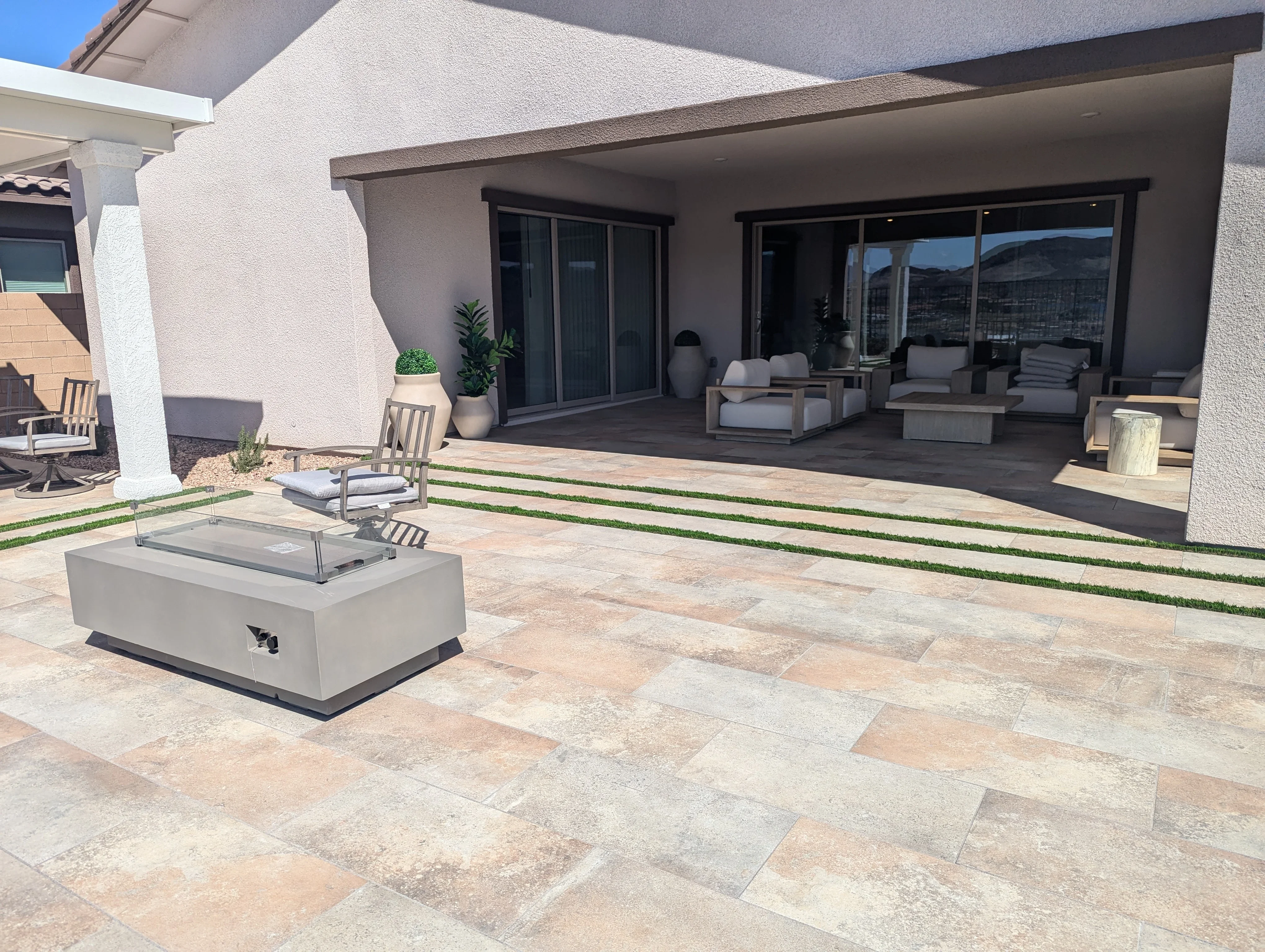 Modern travertine patio with fire pit and mountain views in Las Vegas