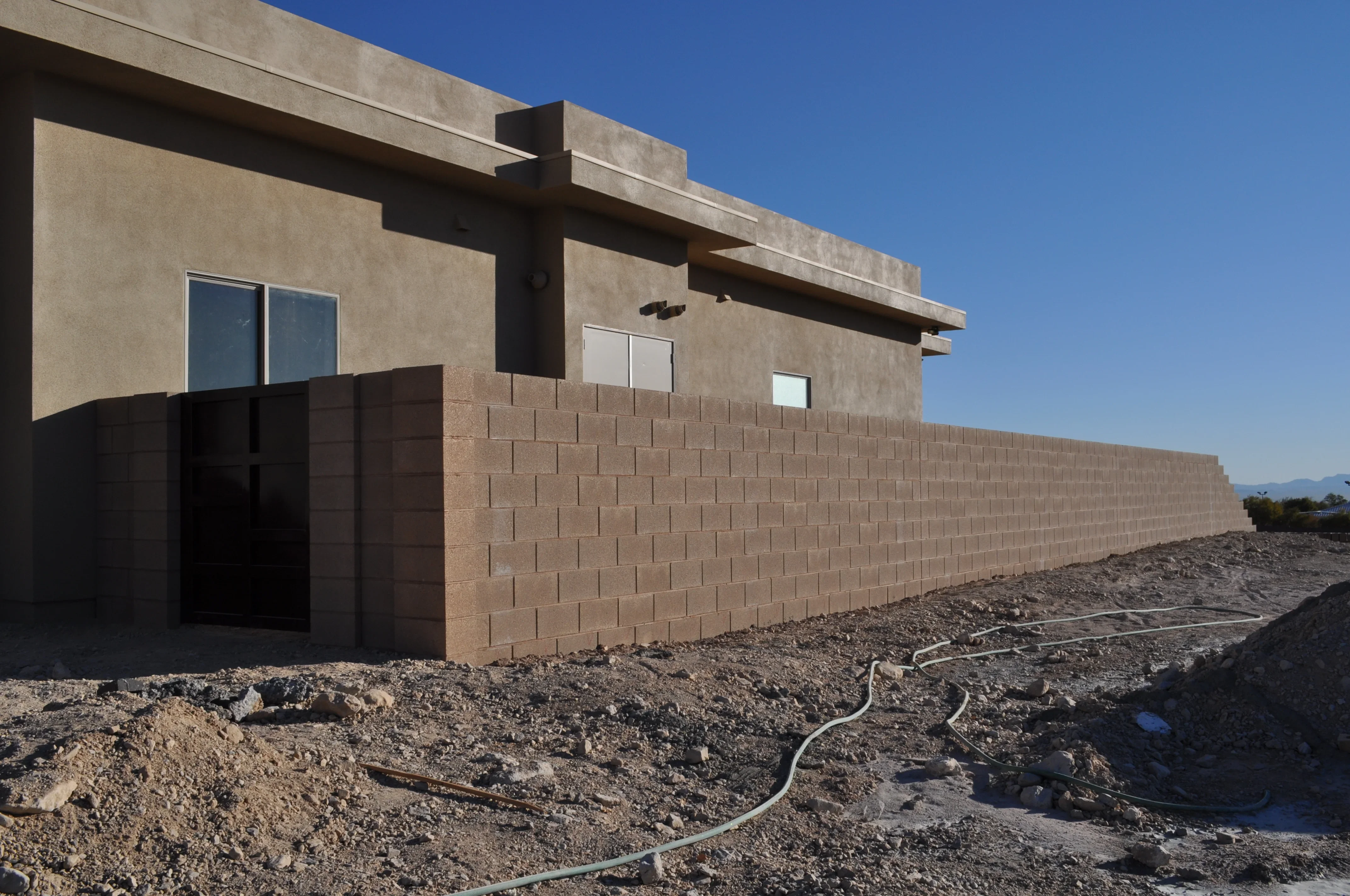 Modern home under construction with clay brick masonry walls and concrete beam structure