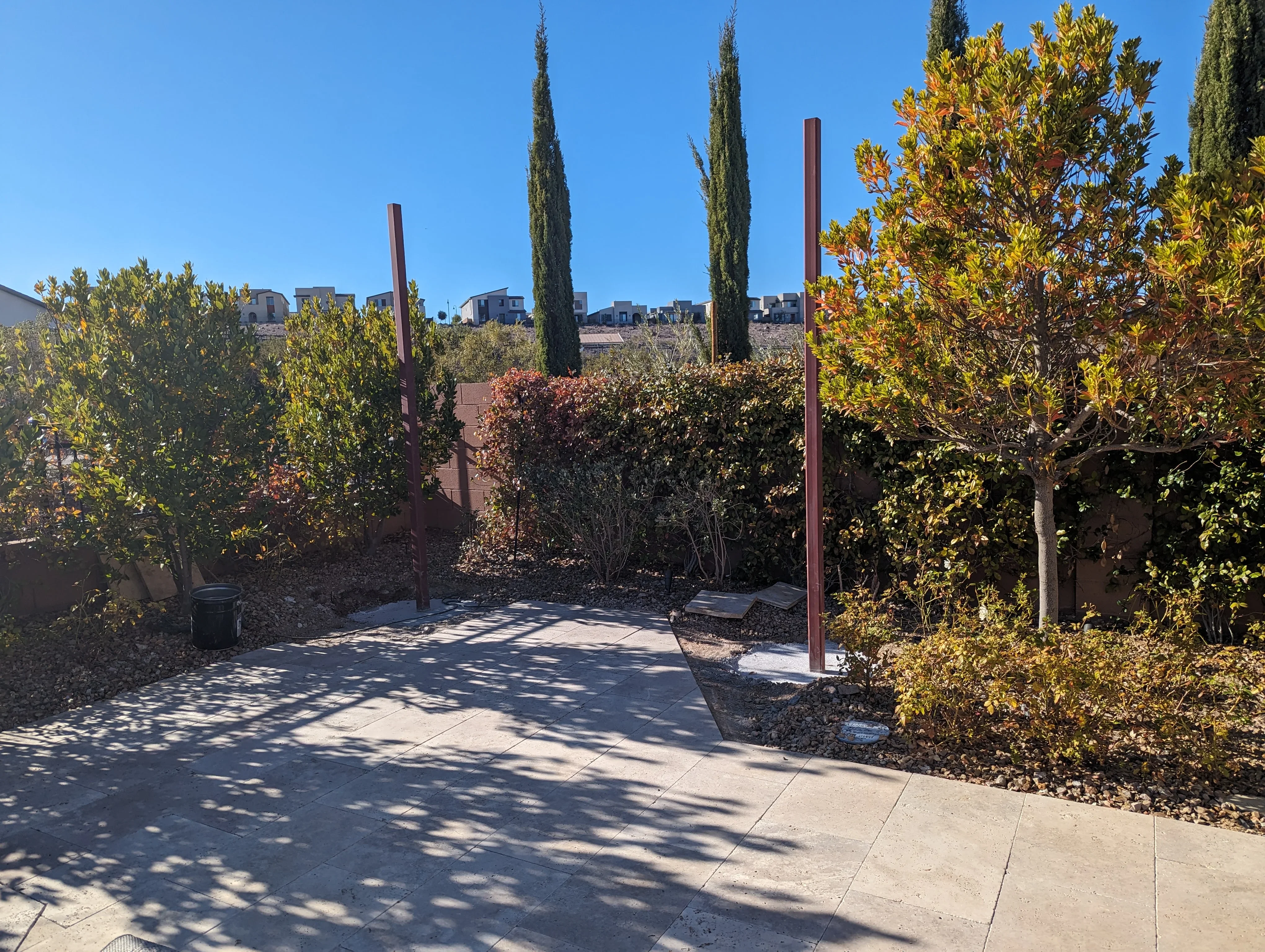Concrete patio with metal posts and desert plantings in Las Vegas courtyard